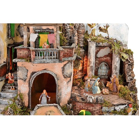 Illuminated nativity scene with fountain and working fire