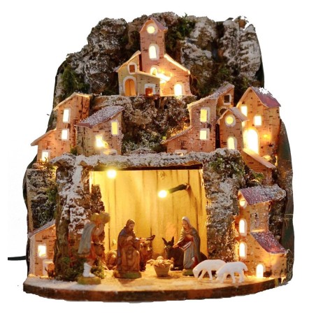 Illuminated snow-covered nativity scene complete with Landi
