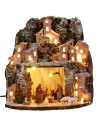 Illuminated snow-covered nativity scene complete with Landi