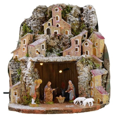 Illuminated snow-covered nativity scene complete with Landi