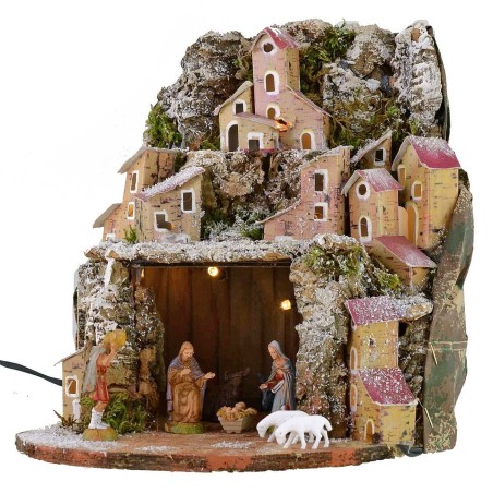 Illuminated snow-covered nativity scene complete with Landi