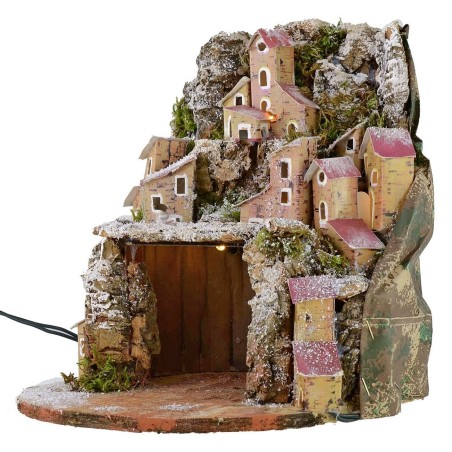Pesebre nevado iluminado con pueblo y cueva de 20x20x24 cm.