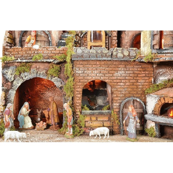 Illuminated Neapolitan nativity scene with oven, waterfall and
