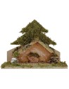 Tree with light-illuminated hut with piles of batteries cm
