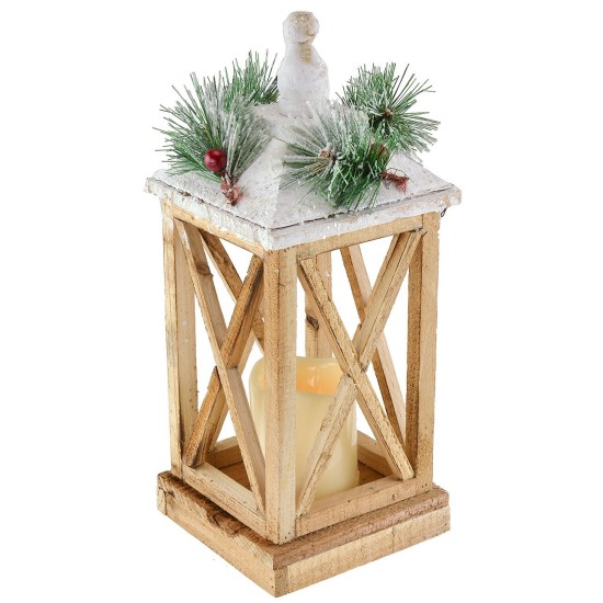 Snow-covered wooden lantern with battery-powered candle