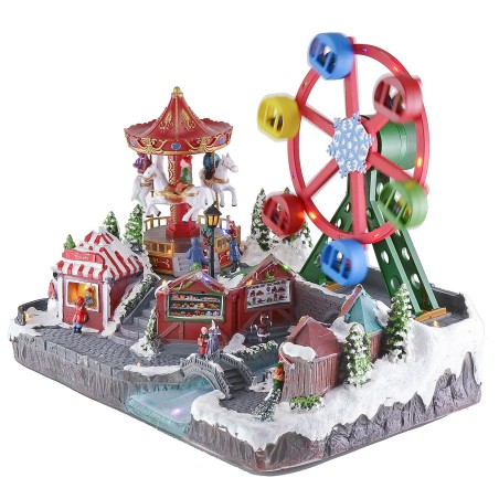 Parque de atracciones navideño con música e iluminación funcionando a