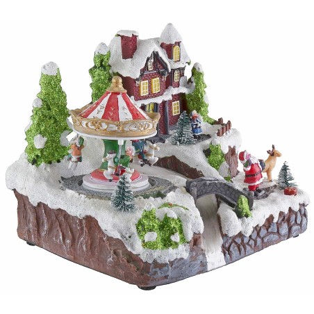 Christmas village with battery-operated carousel with lights