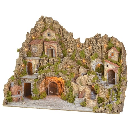 Illuminated nativity scene with cave, fountain, waterfall and