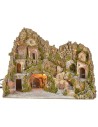 Illuminated nativity scene with cave, fountain, waterfall and fire