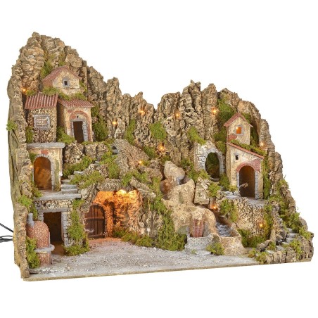 Illuminated nativity scene with cave, fountain, waterfall and