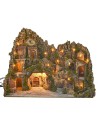 Illuminated nativity scene with cave, fountain, waterfall and fire