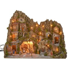 Illuminated nativity scene with a grotto, fountain, waterfall