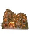 Illuminated nativity scene with a grotto, fountain, waterfall