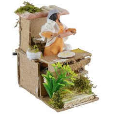 Mujer que extiende la masa en movimiento Mundo Pesebres 2