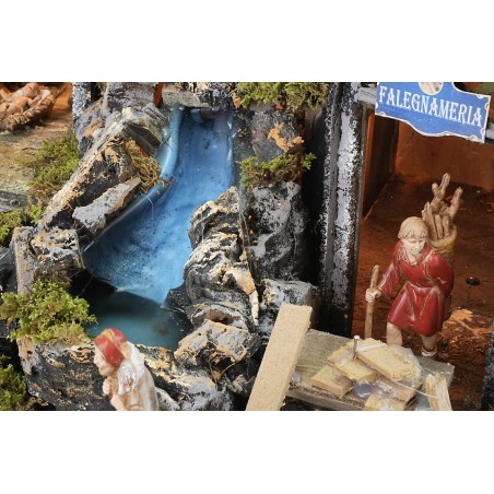 Pesebre iluminado con cascada funcional y efecto de fuego.