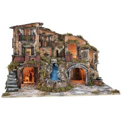 Illuminated nativity scene with waterfall, fountain, and