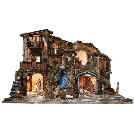 Illuminated nativity scene complete with statues, waterfall, fountain, and