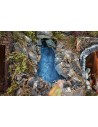 Illuminated nativity scene complete with statues with waterfall, fountain and