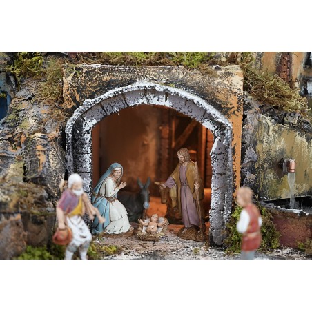 Pesebre iluminado completo de estatuas con cascada, fuente y
