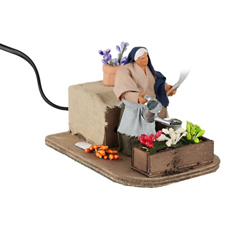 Donna che annaffia 10 cm in movimento per presepe Mondo Presepi