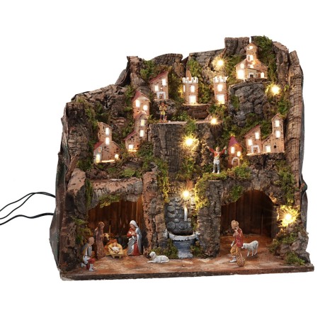 Pesebre completo con estatuas, luces y fuente en funcionamiento completo
