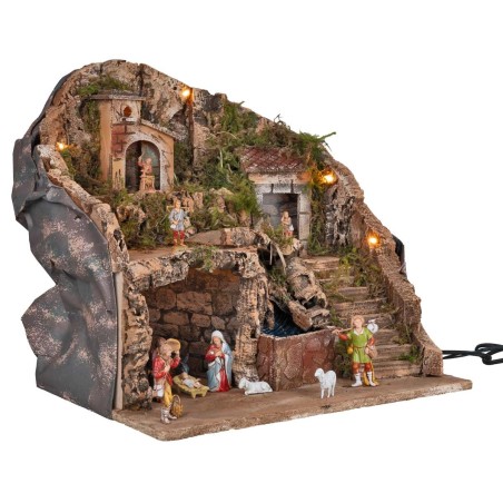 Illuminated nativity scene complete with waterfall and statues