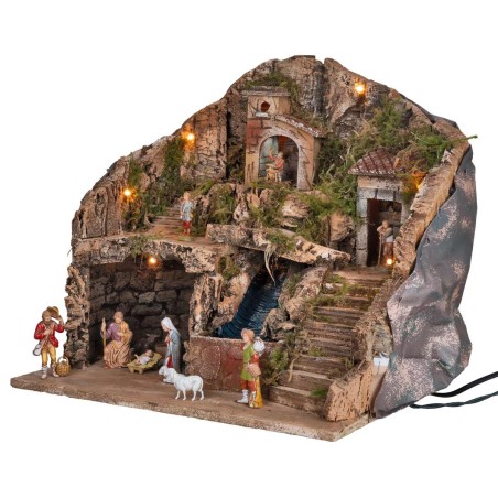 Illuminated nativity scene complete with waterfall and statues