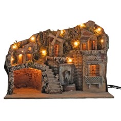 Illuminated nativity scene with a windmill and fountain powered