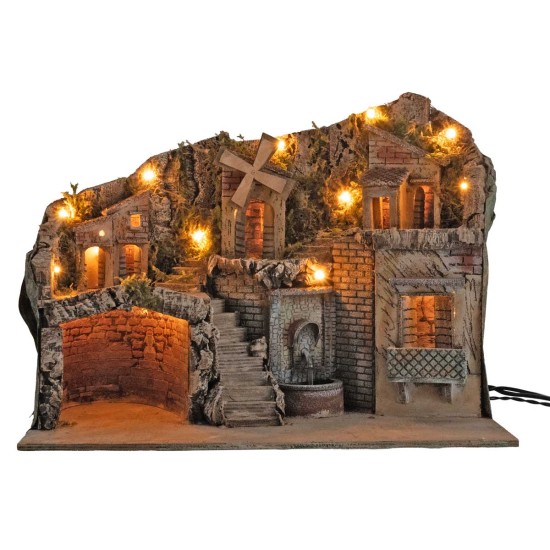 Illuminated nativity scene with a windmill and fountain powered