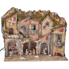 Illuminated nativity scene with arches, oven, mill, and