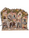 Illuminated nativity scene with arches, oven, mill, and