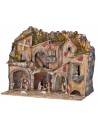 Illuminated nativity scene with arches, oven, mill, and
