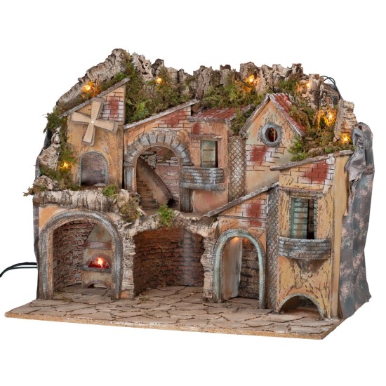 Illuminated nativity scene with arches, oven, mill, and