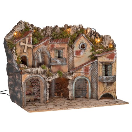 Illuminated nativity scene with arches, oven, mill, and