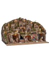 Illuminated nativity scene with caves, little houses, stream, and oven