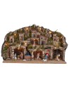 Illuminated nativity scene with caves, little houses, stream