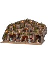 Illuminated nativity scene with caves, little houses, stream, and oven