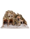 Illuminated nativity scene with oven and small waterfall