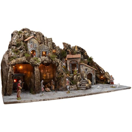 Illuminated nativity scene with oven and small waterfall