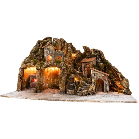 Illuminated nativity scene with oven and small waterfall