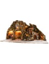 Illuminated nativity scene with oven and small waterfall