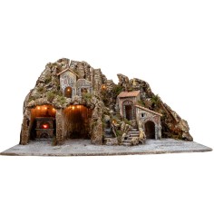 Illuminated nativity scene with oven and small waterfall
