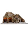 Illuminated nativity scene with oven and small waterfall
