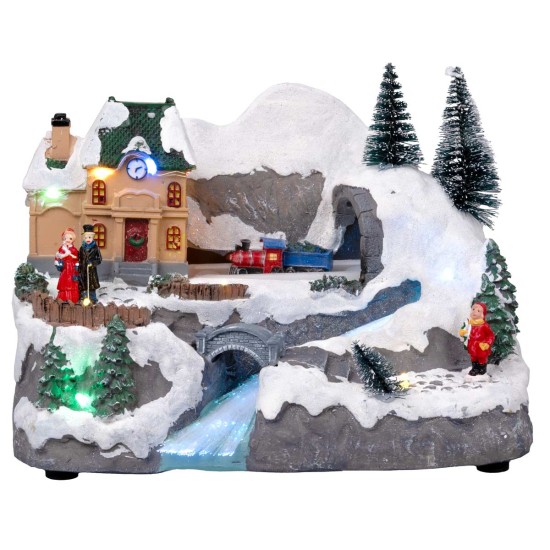 Christmas village with moving train equipped with lights and