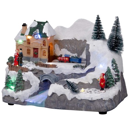 Pueblo navideño con tren en movimiento equipado con luces y