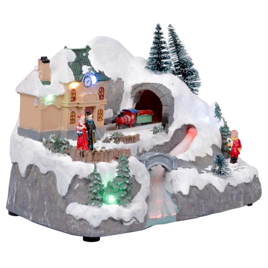 Pueblo navideño con tren en movimiento equipado con luces y