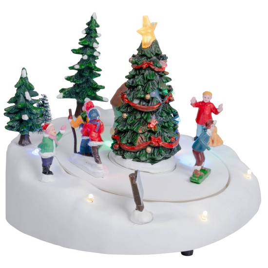 Carrusel navideño con pista de patinaje y árbol de Navidad