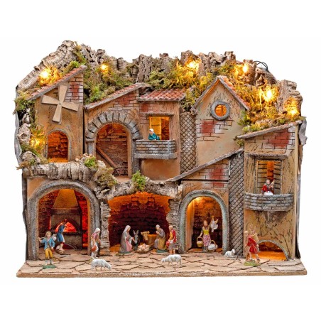 Illuminated nativity scene with arches, oven, mill, and