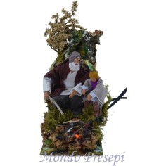 Pastore in movimento che attizza il fuoco funzionante con bimbo