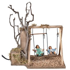 Pareja de niños en columpio serie 12 cm en movimiento